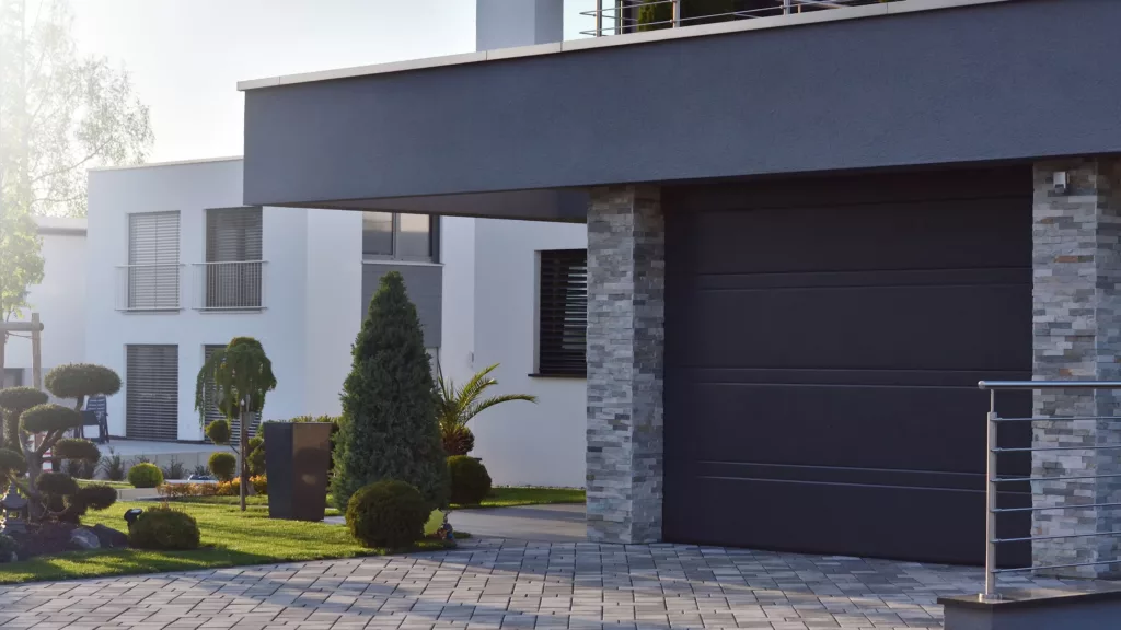 Elegant Orange County home showcasing a modern black garage door design.