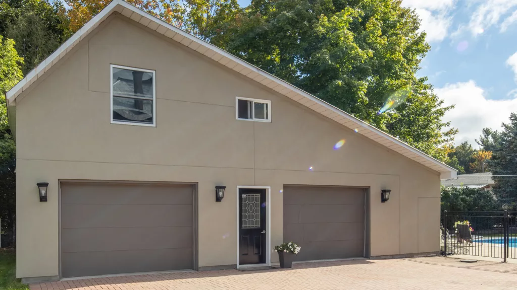 Elegant home featuring dual brown garage doors constructed from premium garage door materials, complementing the residential facade.