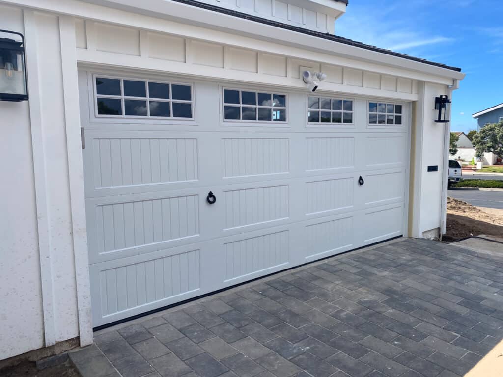 Newly installed white garage door with a distinctive rustic design, expertly fitted by the Urban Garage Door team in Dana Point, Orange County, California.